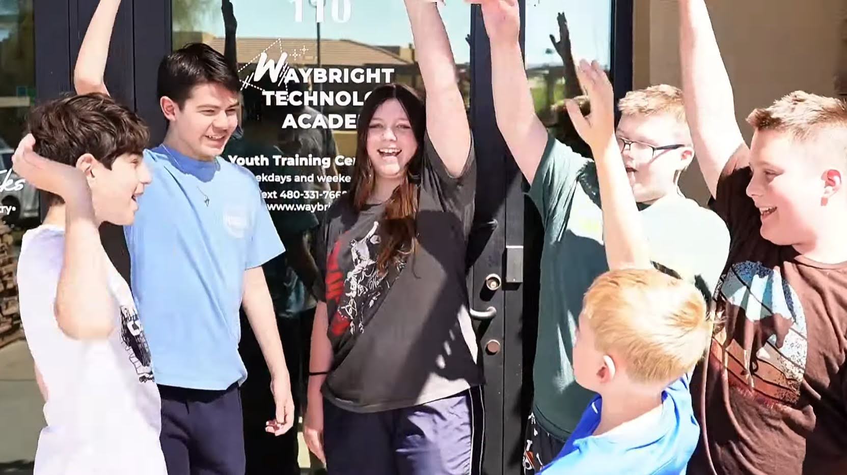 Waybright Academy students working together on technology